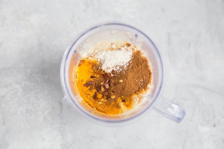 Ingredients for an aromatic turmeric marinade in a blender