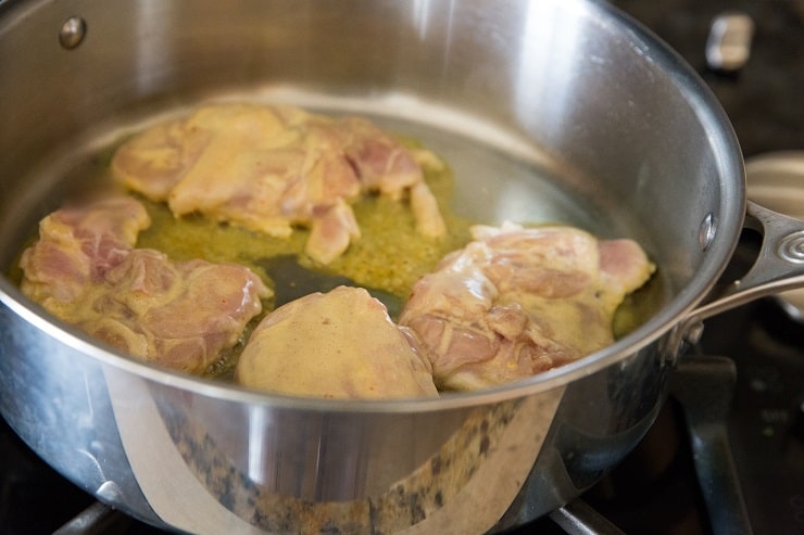 Aromatic Saffron Chicken cooking in a skillet