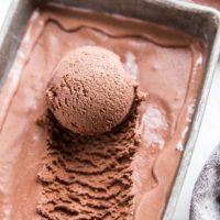 container of chocolate ice cream with scoop taken out