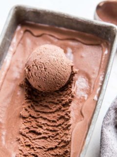container of chocolate ice cream with scoop taken out