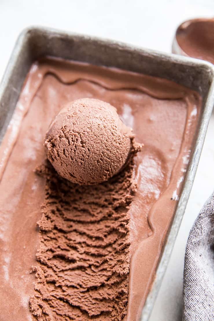 container of chocolate ice cream with scoop taken out