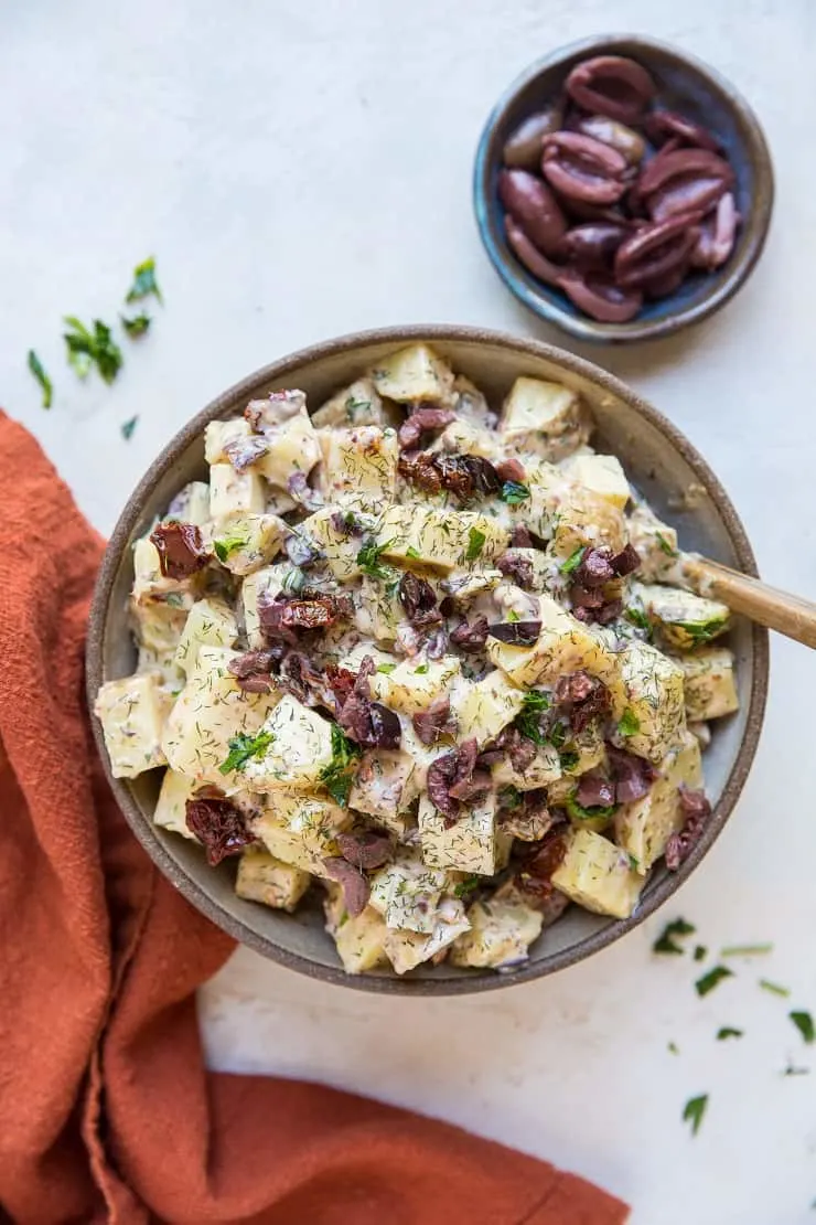 Greek Potato Salad - a healthier potato salad recipe with cider vinaigrette, sun-dried tomatoes, kalamata olives, dill and parsley - an amazing side dish recipe for picnics and BBQs