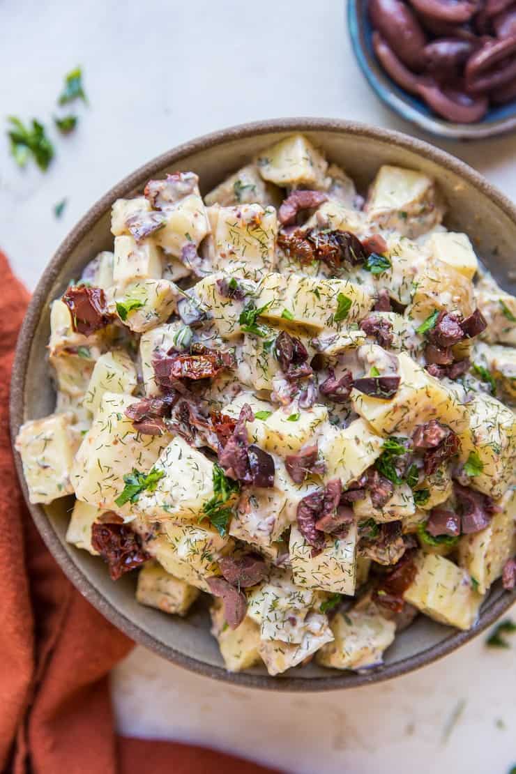 Greek Potato Salad - a healthier potato salad recipe with cider vinaigrette, sun-dried tomatoes, kalamata olives, dill and parsley - an amazing side dish recipe for picnics and BBQs