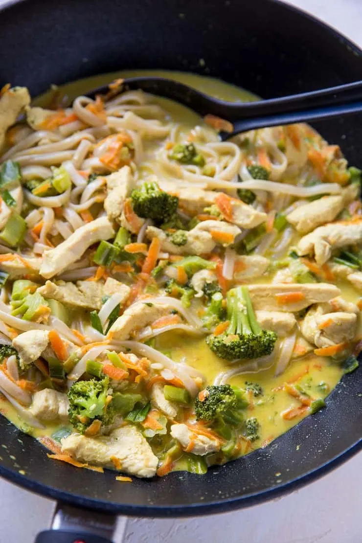 wok with yellow Thai noodles with coconut milk, chicken and vegetables