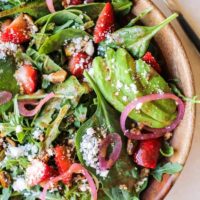 Close up shot of arugula spinach strawberry salad with strawberry vinaigrette