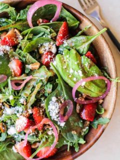 Close up shot of arugula spinach strawberry salad with strawberry vinaigrette