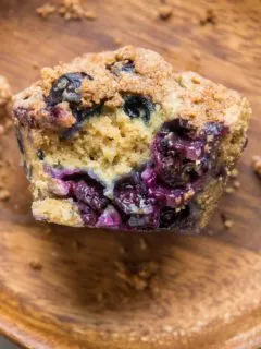 close up of blueberry sourdough muffin with bite taken out
