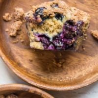 Two wooden plates with blueberry muffins on each