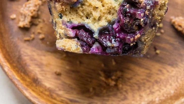 Two wooden plates with blueberry muffins on each