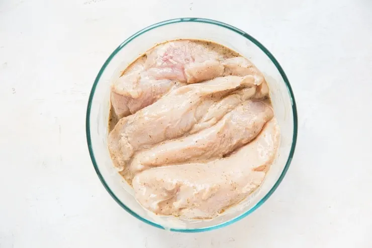 chicken saturated in balsamic marinade in a tupperware container
