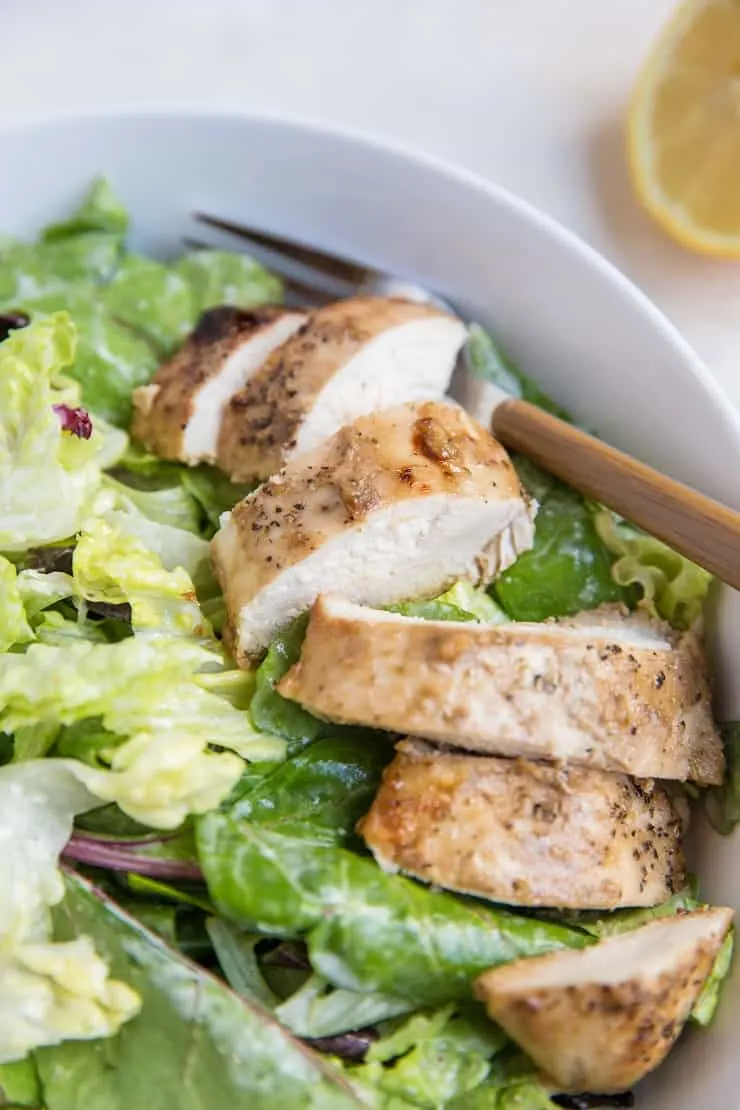 Close up photo of Balsamic Baked Chicken Caesar Salad in a bowl