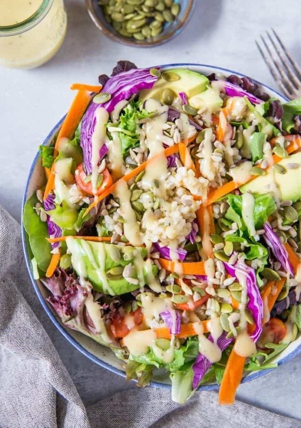 A really great summer salad recipe with greens, carrots, cabbage, avocado, brown rice and homemade dressing