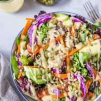 A really great summer salad recipe with greens, carrots, cabbage, avocado, brown rice and homemade dressing