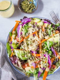 A really great summer salad recipe with greens, carrots, cabbage, avocado, brown rice and homemade dressing