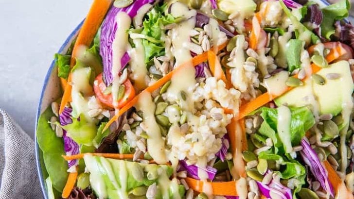 A really great summer salad recipe with greens, carrots, cabbage, avocado, brown rice and homemade dressing