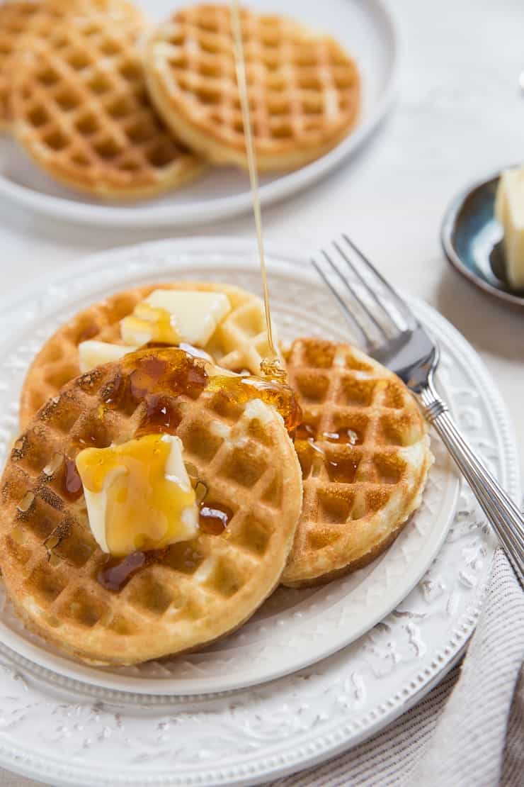 Sourdough waffles with honey being poured on top