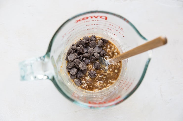 Oatmeal cookie ingredients in a mug with chocolate chips