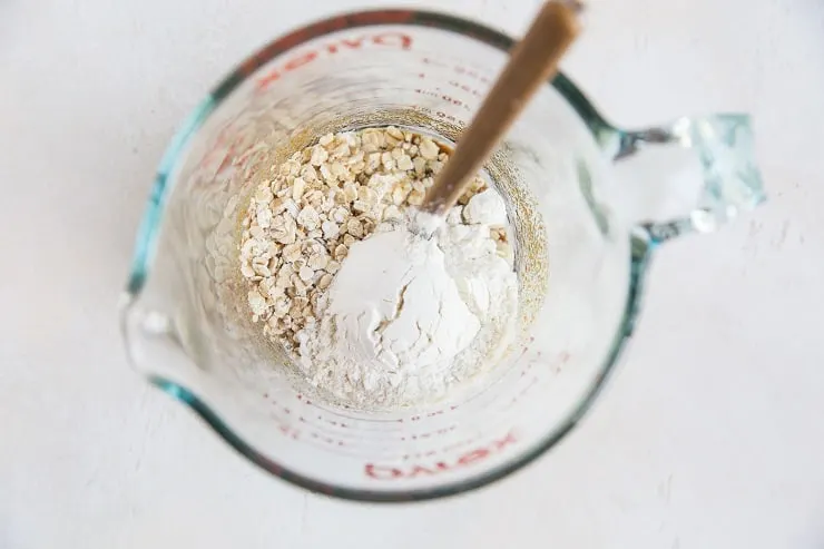 Ingredients for oatmeal cookie in a measuring cup