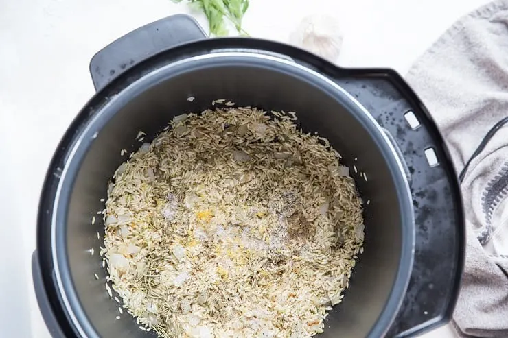 Instant pot with rice and onion cooking