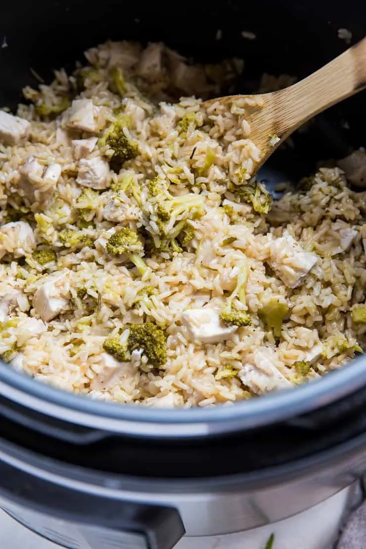 Stirring chopped chicken into Instant Pot with rice