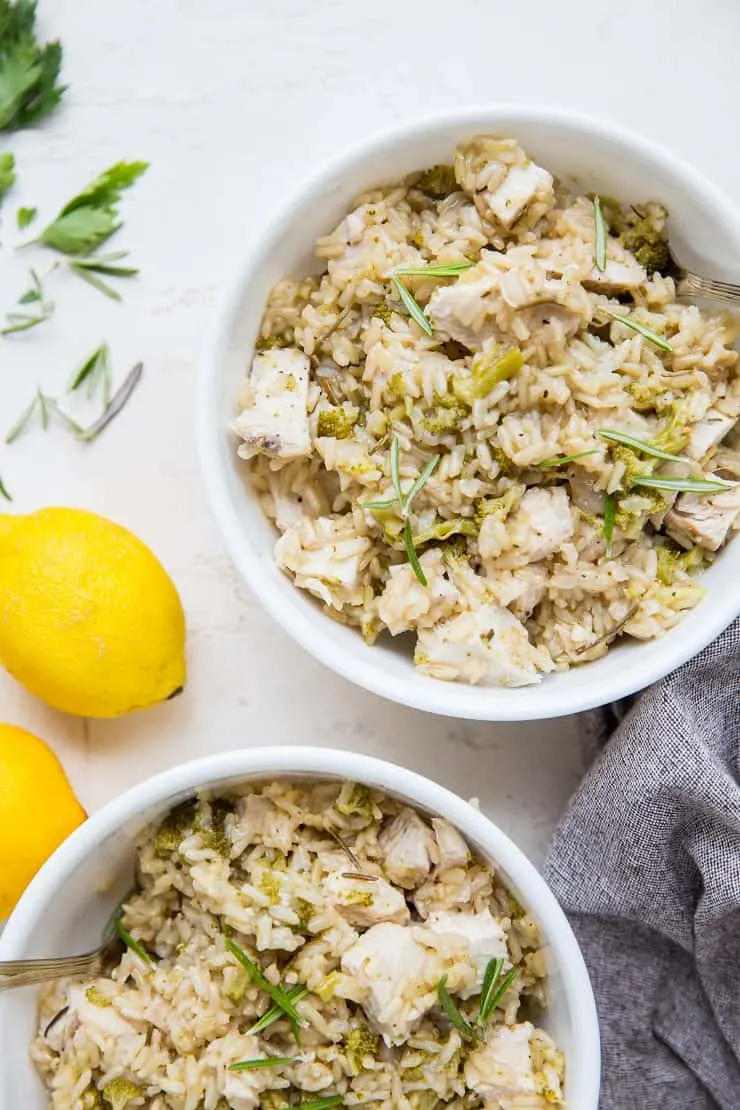 Rosemary Lemon Instant Pot Chicken and Rice - two bowls, a napkin and lemons on the side