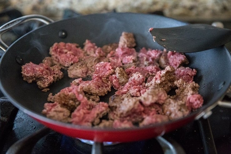 Chopped ground beef cooking in a skillet