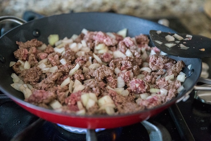 Ground beef and onion cooking in a skillet