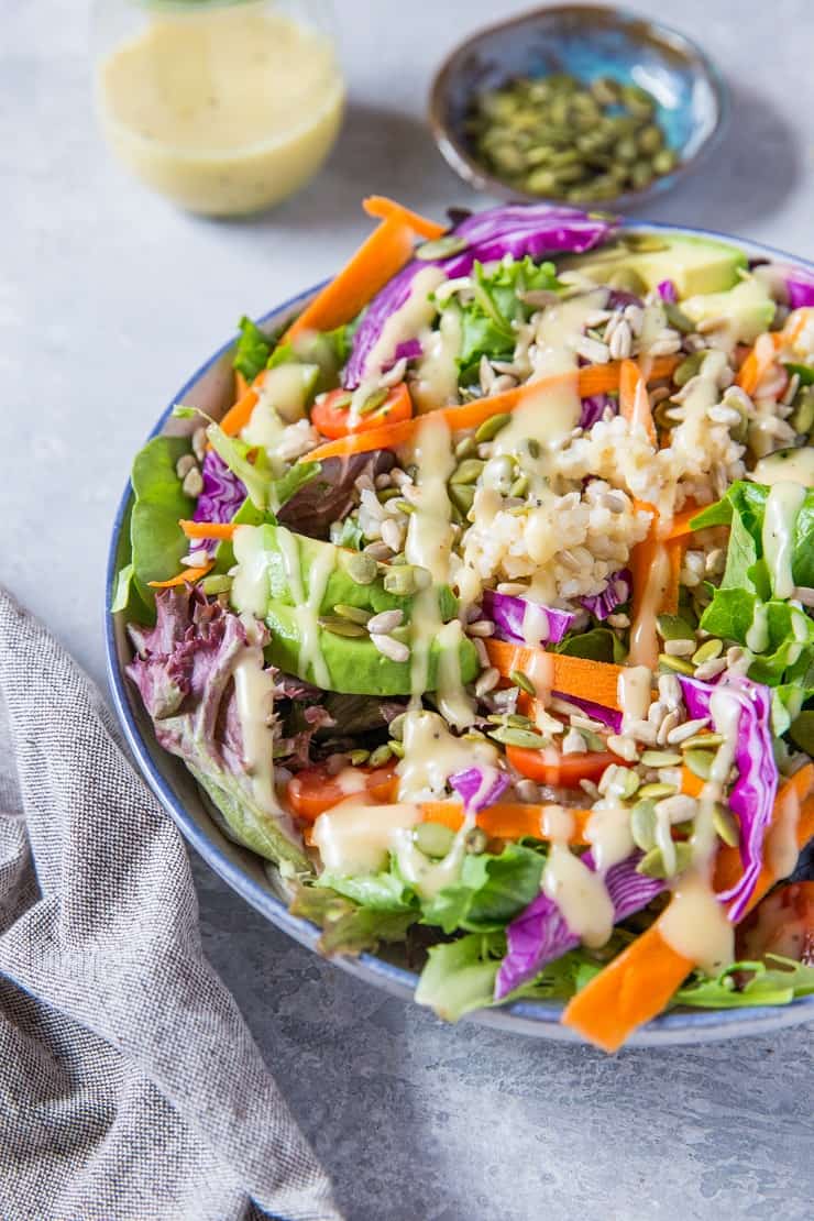 A really great summer salad recipe with greens, carrots, cabbage, avocado, brown rice and homemade dressing