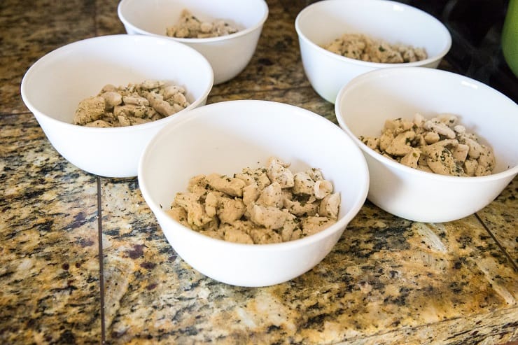 Meal prep bowls with chicken divided among them