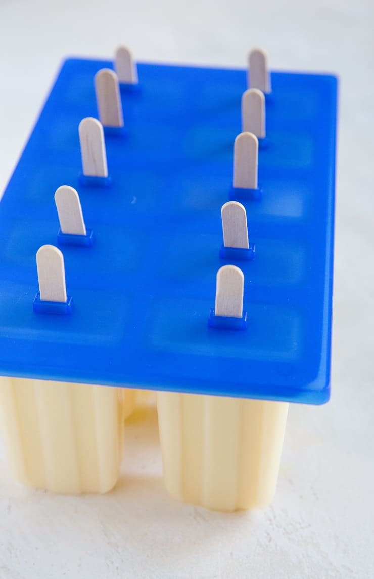 Creamy orange popsicles in a popsicle mold