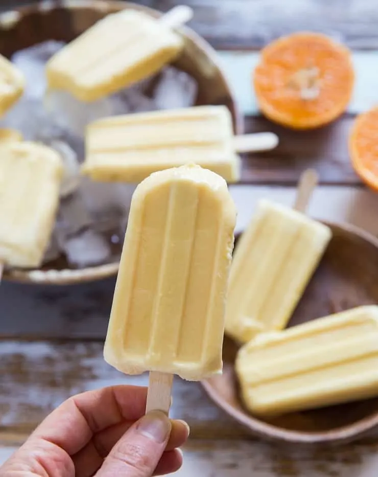 Creamy Orange Popsicles (or creamsicles) made with 2 ingredients. Healthy frozen dessert recipe that is vegan and paleo!