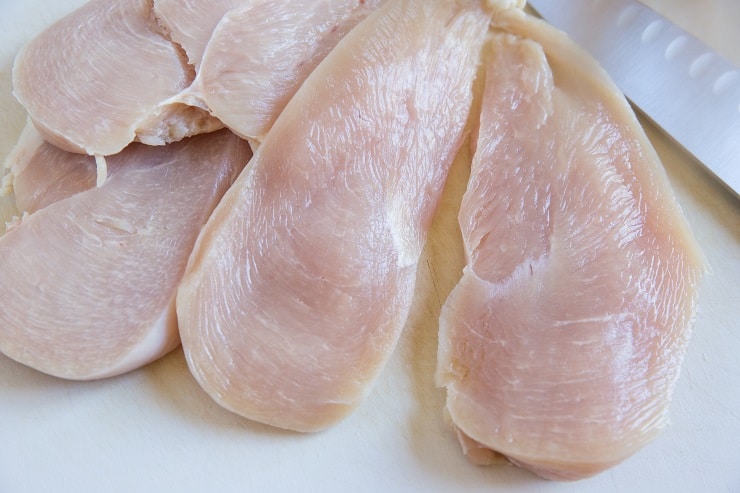 thinly sliced chicken breasts on a plate