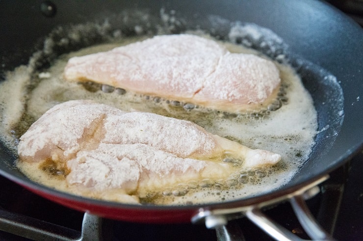 Pan frying breaded chicken in a skillet