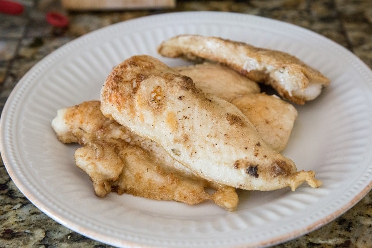 Pan fried breaded chicken on a plate for chicken piccata