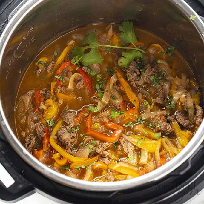 Instant Pot Steak Fajitas from Wholesome Yum - EASY Instant Pot steak fajitas are a delicious and healthy dinner. These steak fajitas in the Instant Pot take just 5 minutes to prep + 7 minutes to cook.  
