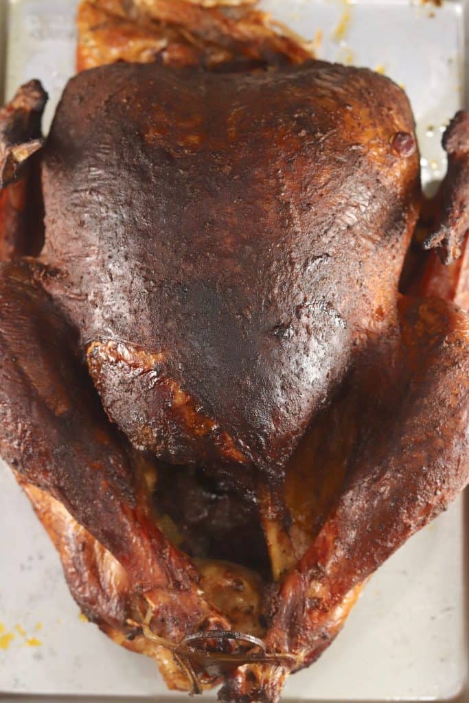 Cajun Smoked Turkey from Out Grilling is loaded with flavor. A great addition to any holiday meal or great to make ahead for sandwiches. Easy to make at home and so much tastier than what you will find at the deli.