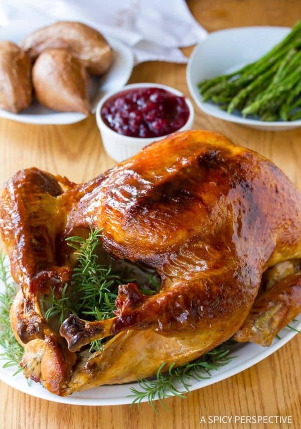 Cranberry Jalapeno Honey Baked Turkey from A Spicy Perspective  A sweet and spicy approach to your holiday meal! The most amazing turkey brine and glaze recipe, that produces a golden glistening juicy turkey with a crispy crust!