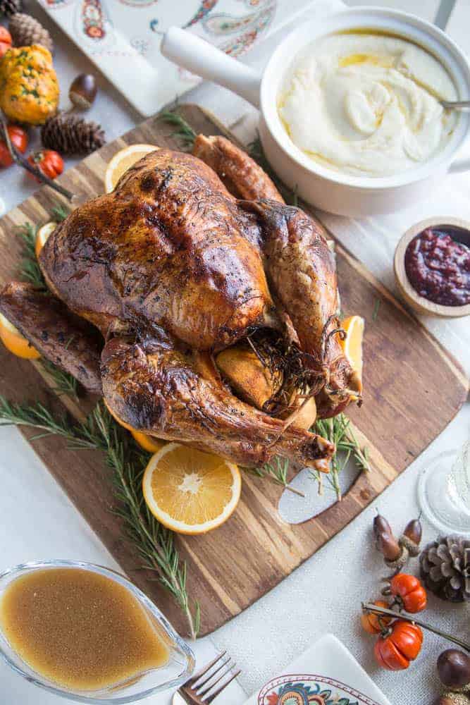 Dry Brine Turkey with Orange Rosemary Herb Butter from Perry’s Plate  Dry brining is like wet brining without the water. It’s more like a seasoning rub that you leave on the bird for a few days before cooking — at least 3 days and up to 4-5 days. This recipe uses salt, black pepper, and coconut sugar for the dry brine and includes a rosemary herb compound butter for roasting.