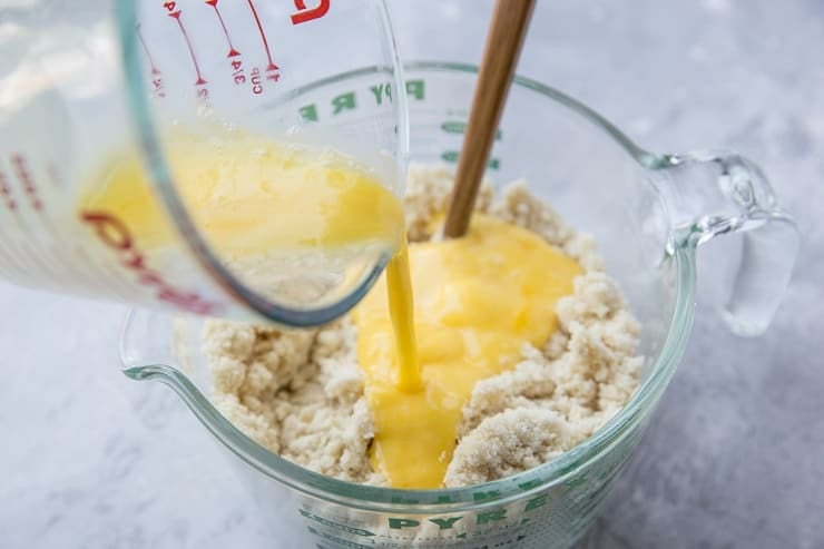 Add the beaten egg to the pie crust mixture