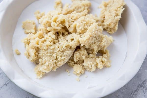 Transfer pie crust dough to a parchment-lined pie pan