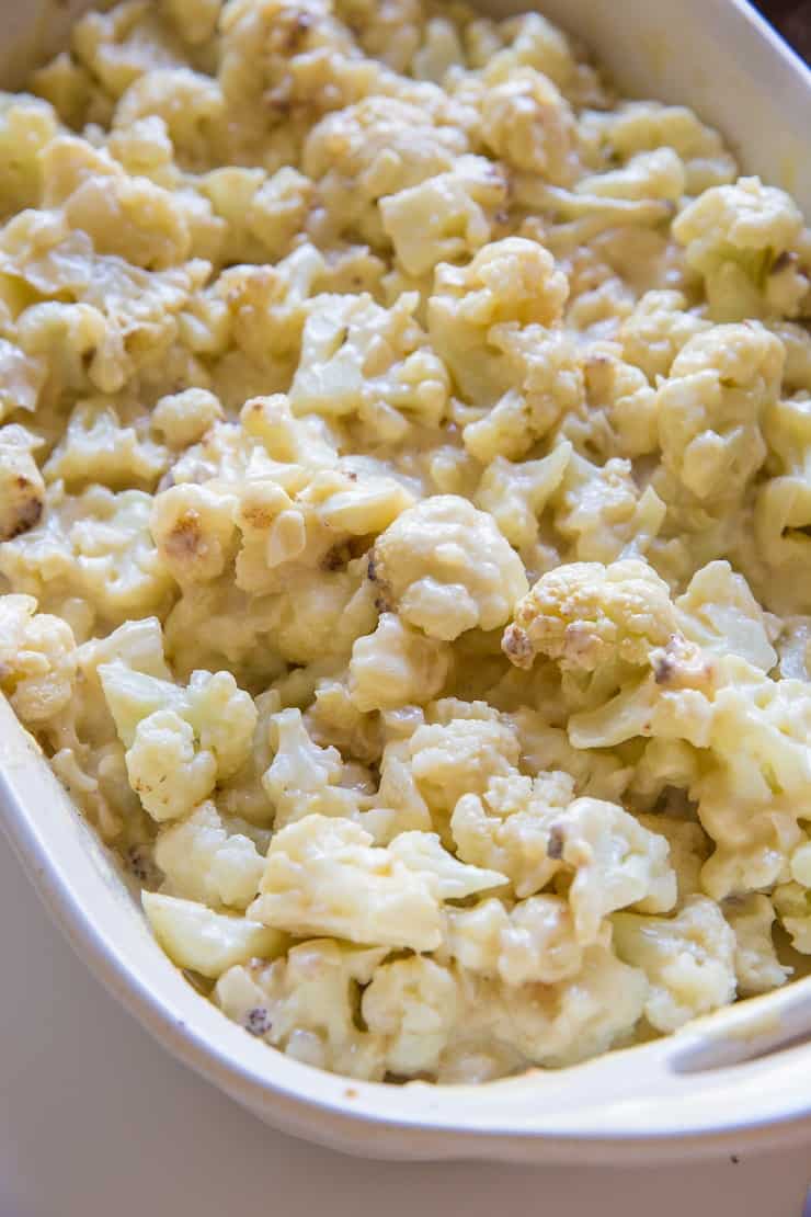 Roasted cauliflower in creamy sauce in casserole dish