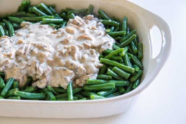 Green beans and creamy sauce in a large baking dish.