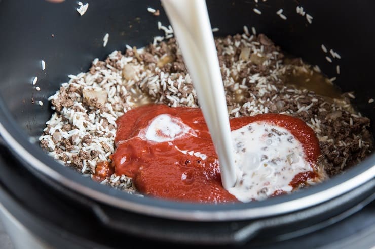 Add the broth, tomato sauce, and coconut milk