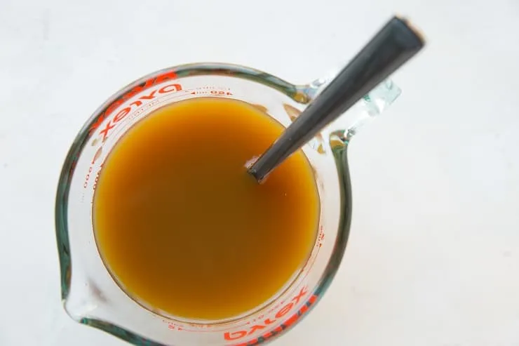 Apple cider, cider vinegar and molasses in a measuring cup
