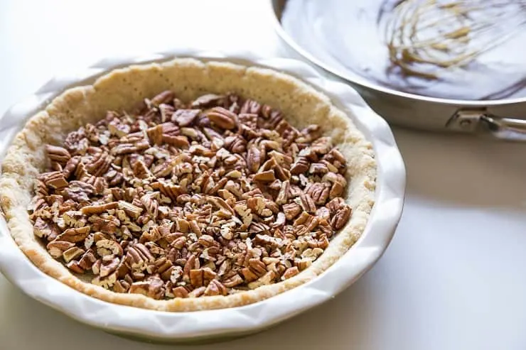 Add the pecans to the prepared pie crust in an even layer