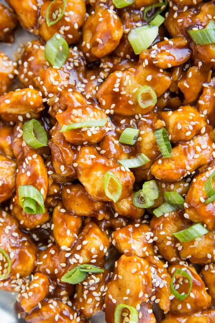 Easy Paleo General Tso's Chicken - sweet and sour chicken recipe with crispy saucy chicken served over cauliflower rice.