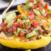 Keto Spaghetti Squash Burrito Bowls with avocado, tomato, salsa, cheese, spiced ground beef, and more!