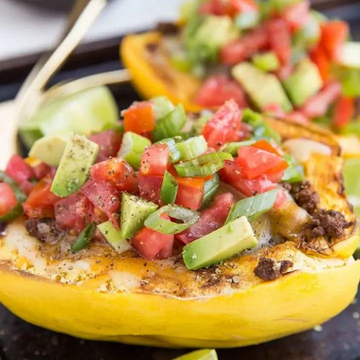 Keto Spaghetti Squash Burrito Bowls with avocado, tomato, salsa, cheese, spiced ground beef, and more!