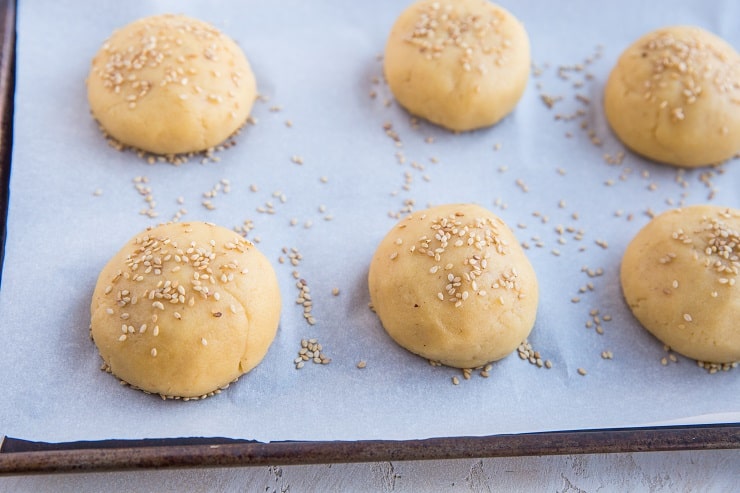 Place balls of dough on a baking sheet and sprinkle with sesame seeds