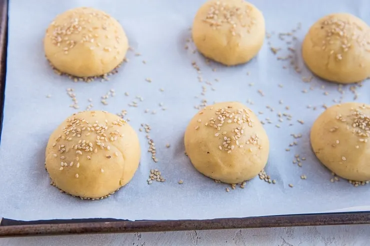 Place balls of dough on a baking sheet and sprinkle with sesame seeds